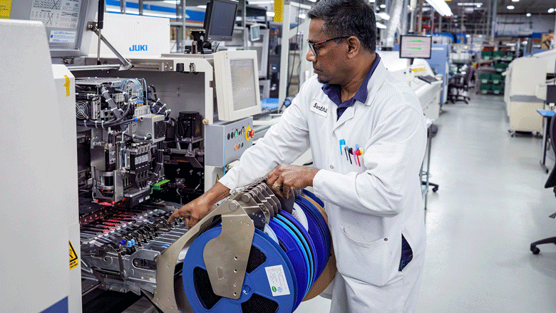 default-2 An animation gif showing workers assembling printed circuit boards at various stages of the process in a facility.