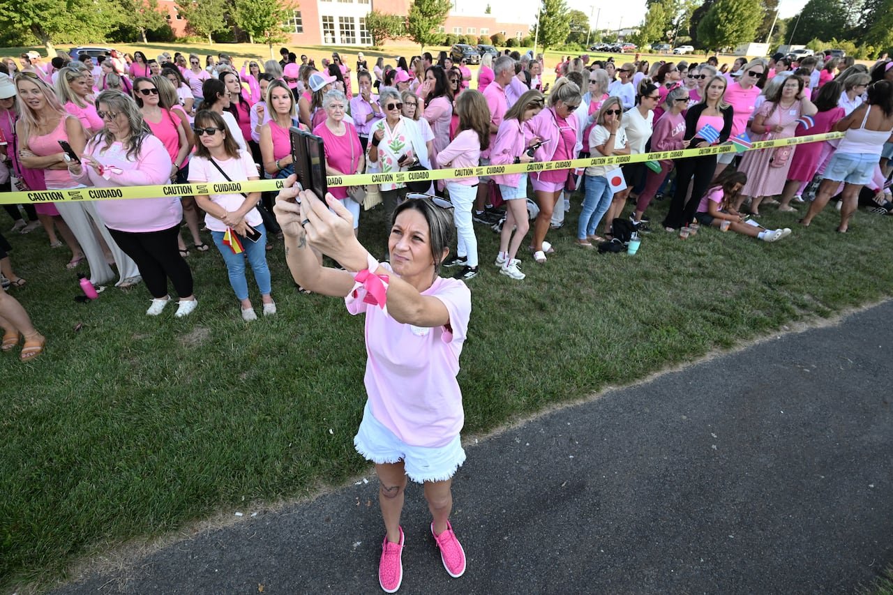 A group of women in pink outside a courthouse supporting Lindsay Clancy