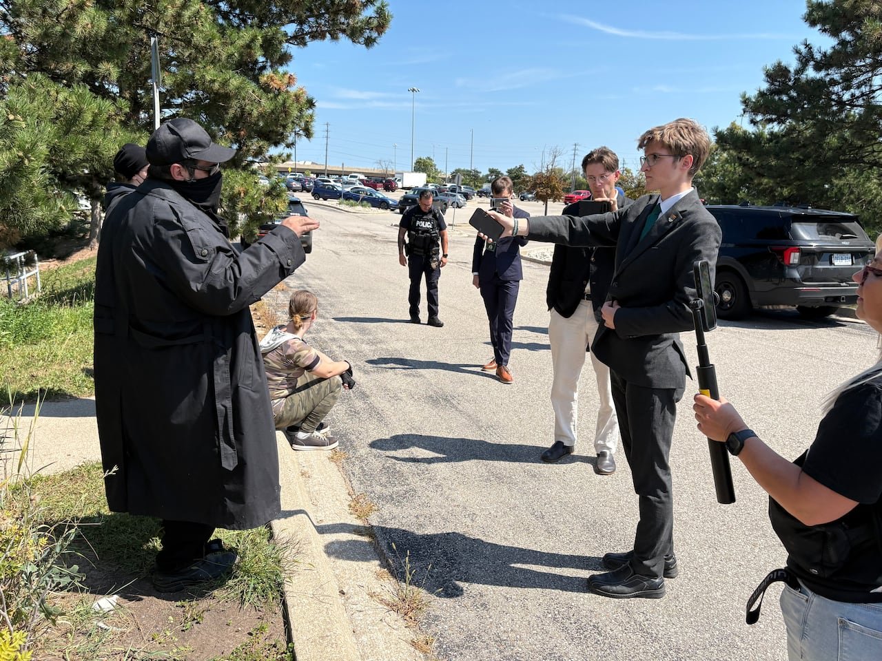 Max Genest, a Dominion Society member, engages with a protester outside The Atrium Banquet and Conference Centre in Burlington.