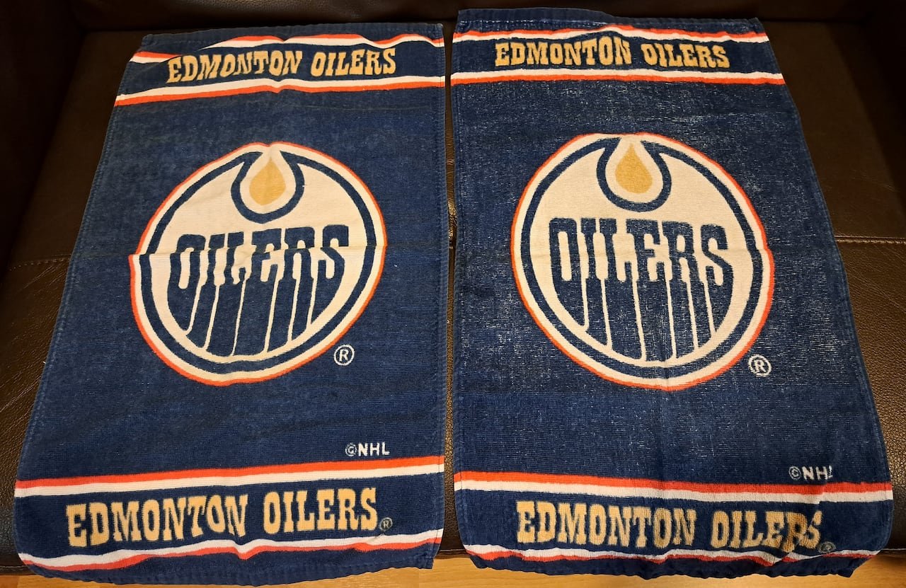 default-372 A pair of blue towels with a logo reading the word "Oilers" and additional text reading Edmonton Oilers.