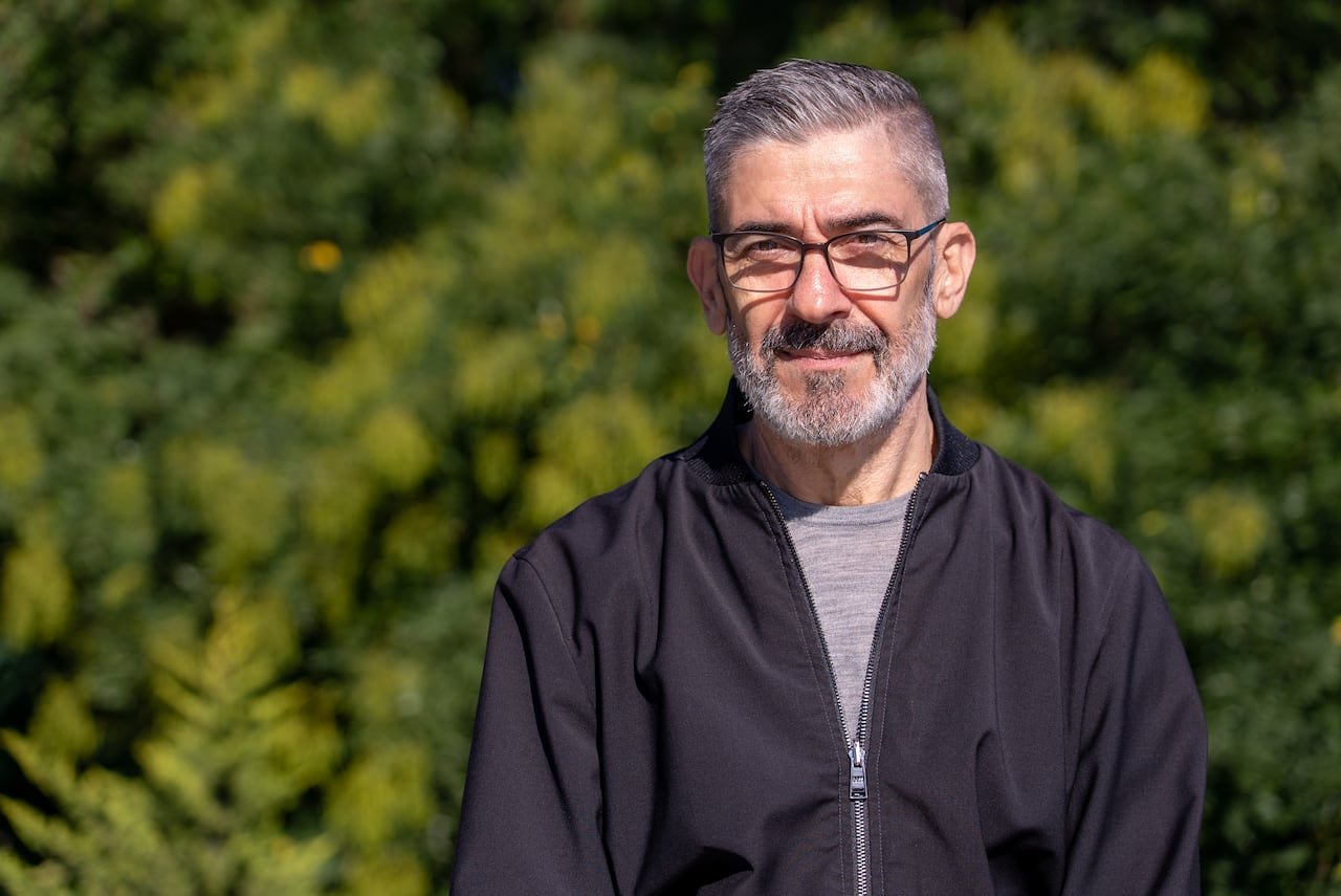 A man poses with a straight face